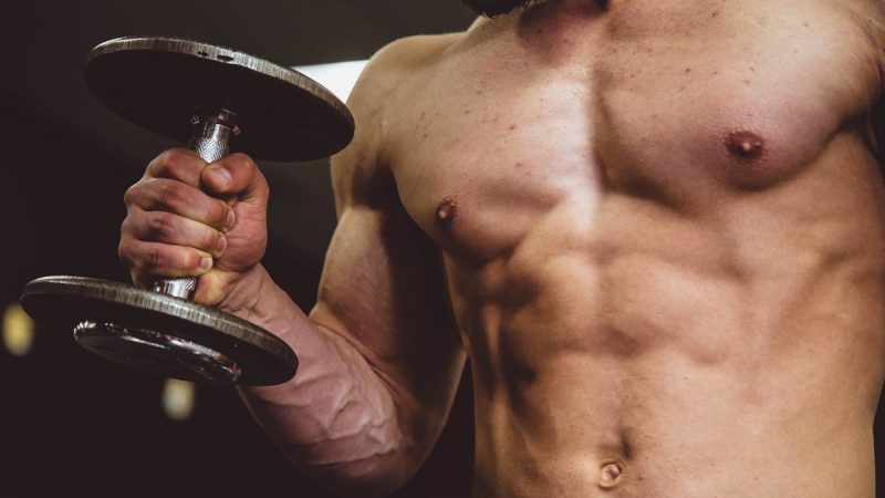 man holding black dumbbell